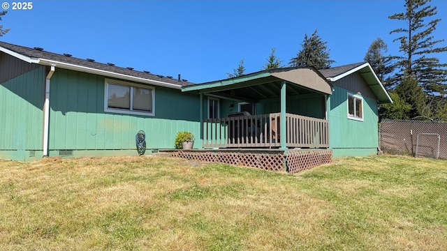 view of front of home with fence, a wooden deck, a front lawn, and crawl space