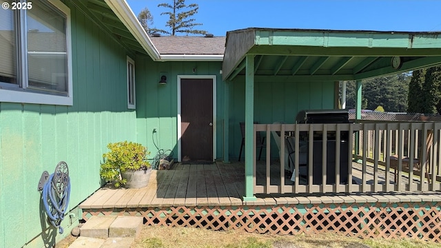 view of exterior entry with a wooden deck