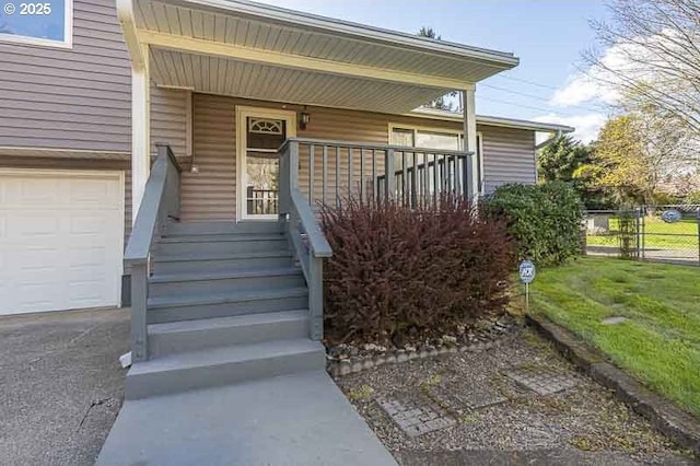 1216 Montgomery Pl NE, Albany, OR 97321 - view of exterior entry featuring a porch, a garage, and fence