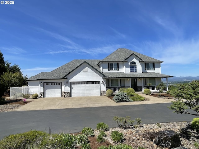view of front of house with a porch, a garage, driveway, roof with shingles, and stone siding