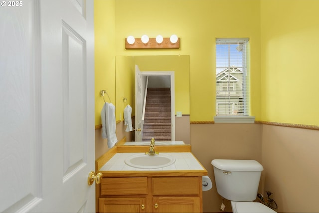 bathroom featuring toilet and vanity