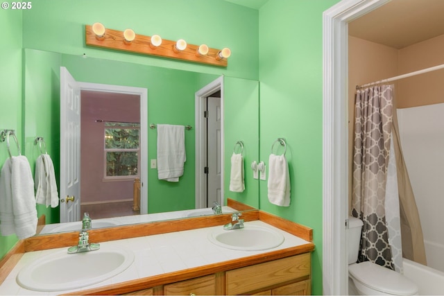 full bath featuring double vanity, toilet, shower / tub combo, and a sink