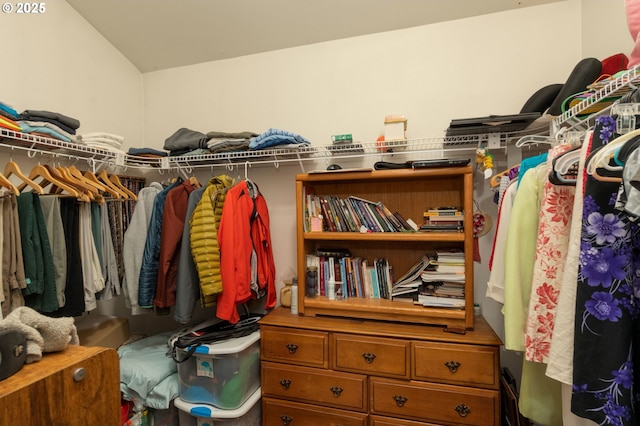 walk in closet featuring vaulted ceiling