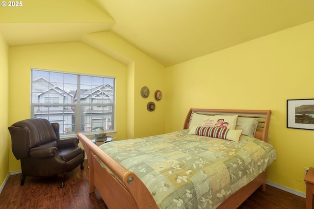 bedroom with baseboards, lofted ceiling, and wood finished floors