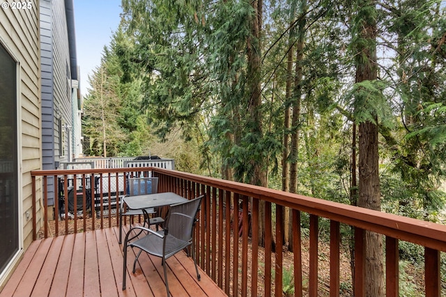 wooden terrace with outdoor dining area