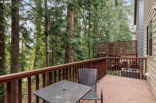 wooden terrace with outdoor dining space