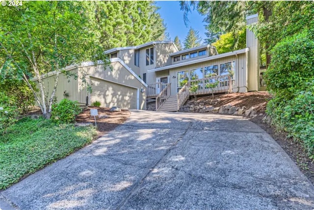 view of front of home with a garage and a wooden deck