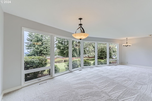 unfurnished sunroom featuring a notable chandelier