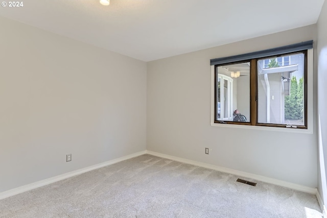 unfurnished room featuring carpet