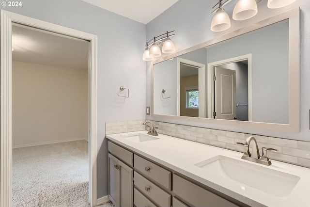 bathroom with vanity and tasteful backsplash