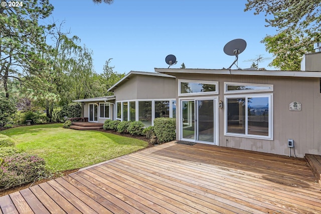 wooden deck featuring a yard and a sunroom