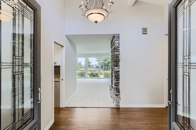 entrance foyer with dark hardwood / wood-style floors and a chandelier