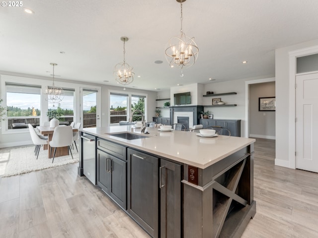 1703 S Farm View Loop, Ridgefield, WA 98642 - kitchen featuring a chandelier, a sink, open shelves, a fireplace, and light countertops