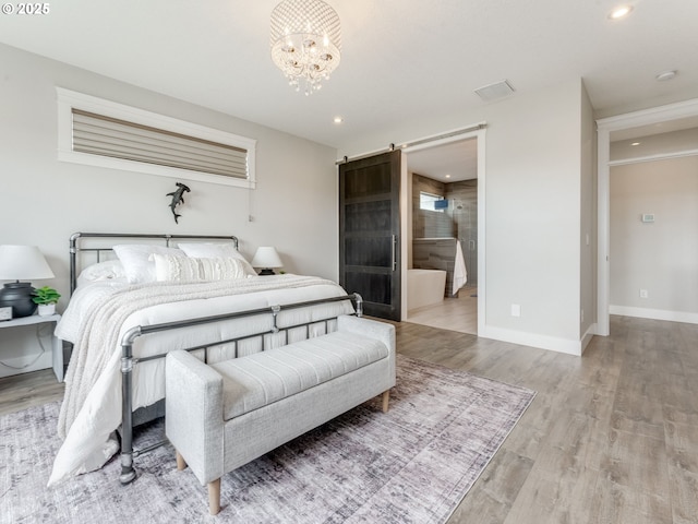 1703 S Farm View Loop, Ridgefield, WA 98642 - bedroom with a barn door, a chandelier, wood finished floors, baseboards, and recessed lighting