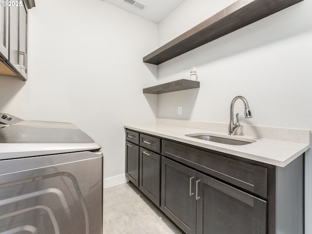 1703 S Farm View Loop, Ridgefield, WA 98642 - laundry room with cabinet space, washing machine and clothes dryer, light tile patterned floors, and baseboards