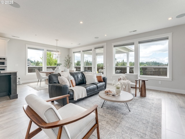 1703 S Farm View Loop, Ridgefield, WA 98642 - living room featuring recessed lighting, light wood-style floors, a chandelier, and baseboards