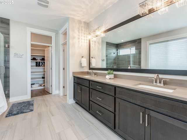 1703 S Farm View Loop, Ridgefield, WA 98642 - bathroom featuring a stall shower, double vanity, a spacious closet, and baseboards