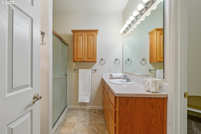 bathroom with an enclosed shower and vanity