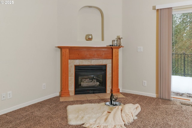 living room with carpet floors and a tiled fireplace