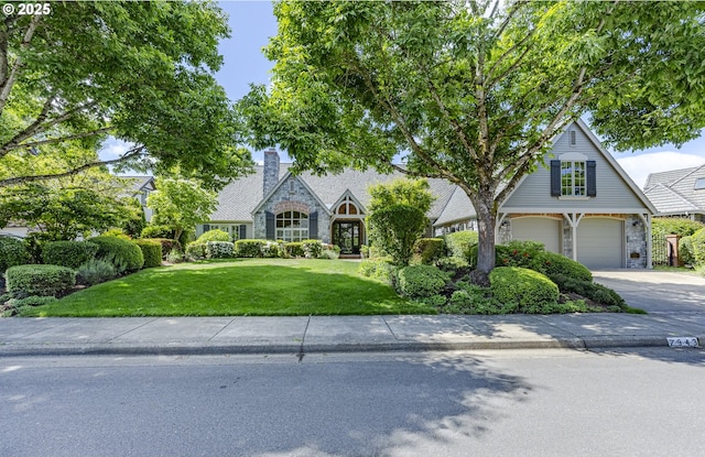 2943 Riverwalk Loop, Eugene, OR 97401 - view of front facade with a front lawn, an attached garage, driveway, and stone siding