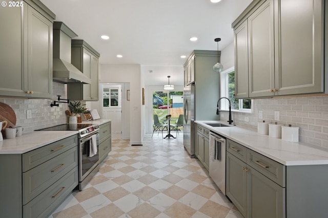 152 S Palatine Hill Rd, Portland, OR 97219 - kitchen with appliances with stainless steel finishes, wall chimney range hood, decorative backsplash, hanging light fixtures, and recessed lighting