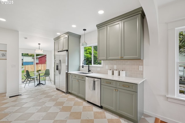 152 S Palatine Hill Rd, Portland, OR 97219 - kitchen with appliances with stainless steel finishes, gray cabinetry, backsplash, light countertops, and hanging light fixtures