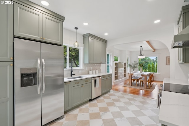 152 S Palatine Hill Rd, Portland, OR 97219 - kitchen with appliances with stainless steel finishes, decorative backsplash, pendant lighting, arched walkways, and recessed lighting