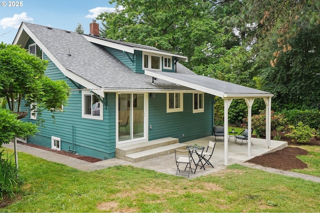 152 S Palatine Hill Rd, Portland, OR 97219 - rear view of house featuring roof with shingles, a lawn, a patio, and a chimney