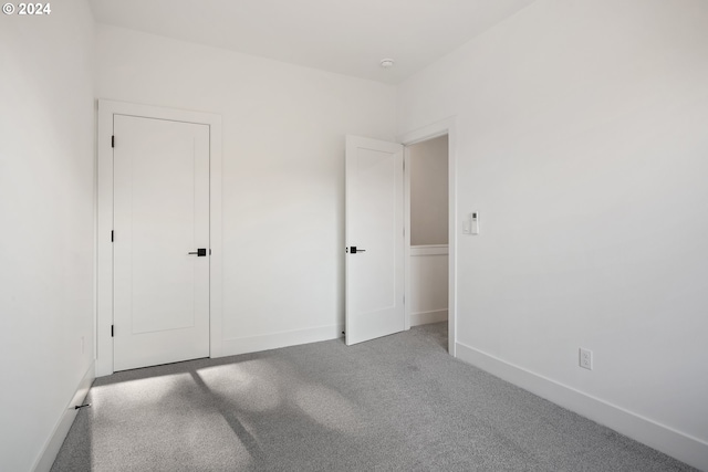 unfurnished bedroom featuring light colored carpet