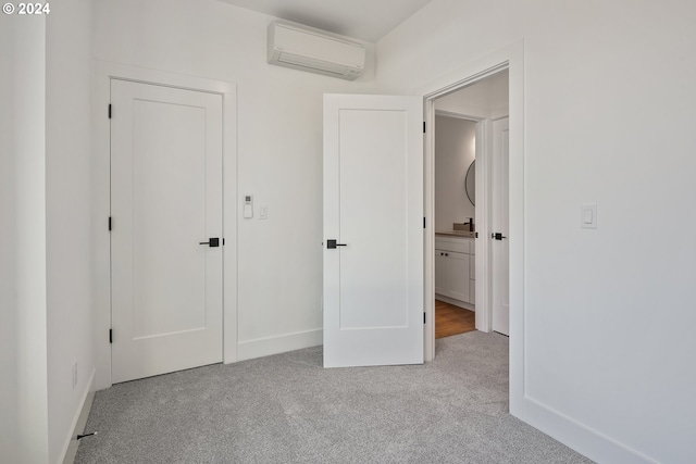 unfurnished bedroom with light carpet and an AC wall unit