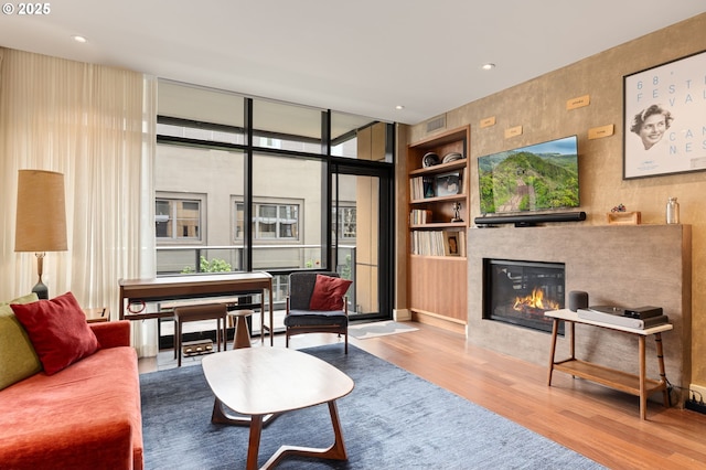 311 NW 12th Ave Unit 603, Portland, OR 97209 - living area featuring a tiled fireplace, recessed lighting, and wood finished floors