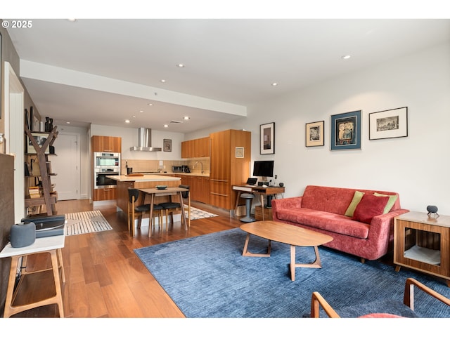 living area with recessed lighting and wood finished floors