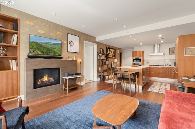 311 NW 12th Ave Unit 603, Portland, OR 97209 - living area with a tiled fireplace, recessed lighting, and light wood-style floors