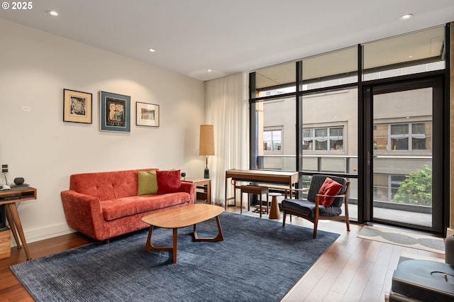 311 NW 12th Ave Unit 603, Portland, OR 97209 - living room with baseboards, recessed lighting, wood finished floors, and a wall of windows