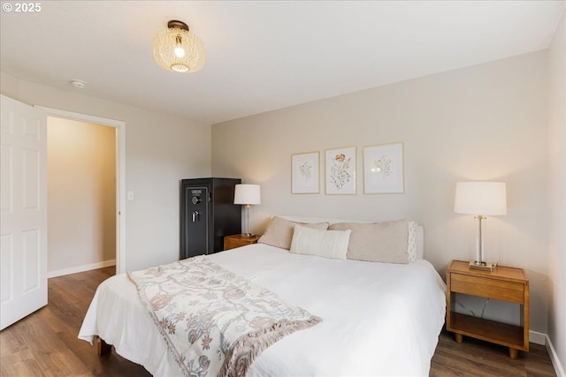 bedroom with baseboards and wood finished floors