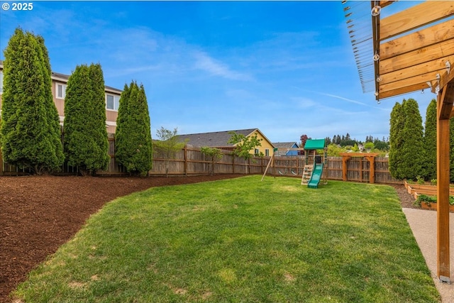 view of yard with a fenced backyard and a playground