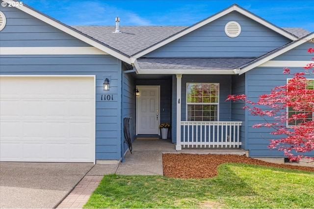 ranch-style house featuring a garage, roof with shingles, and covered porch