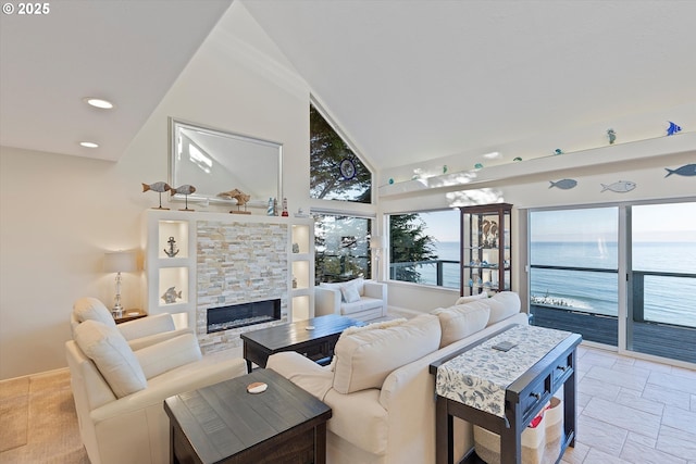 living room featuring a water view, a fireplace, and high vaulted ceiling