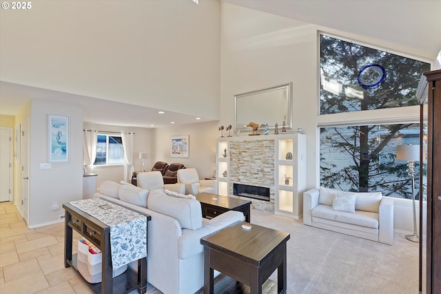 living room featuring a high ceiling and a fireplace