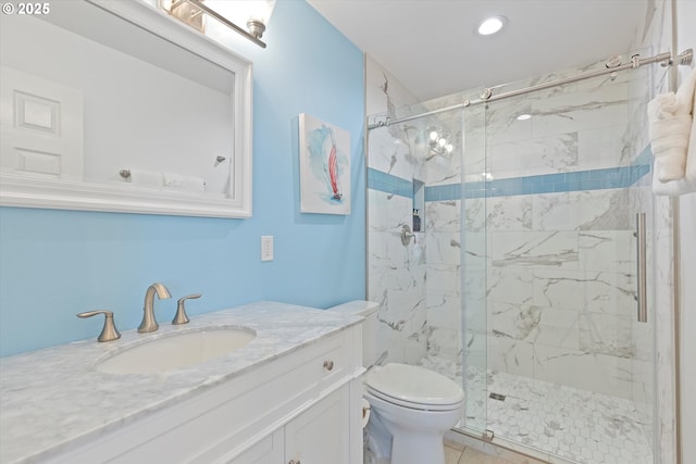 bathroom featuring toilet, vanity, and walk in shower