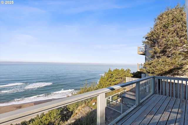 deck featuring a beach view and a water view