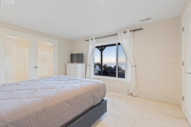 carpeted bedroom with french doors