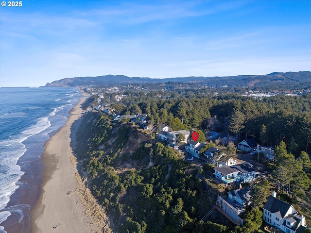 drone / aerial view with a beach view and a water view