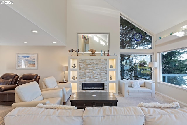 living room with a stone fireplace, light carpet, and high vaulted ceiling