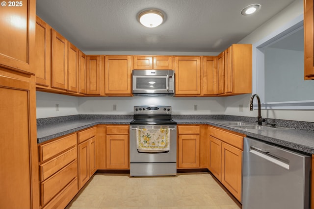 6410 SW 204th Pl, Beaverton, OR 97078 - kitchen with appliances with stainless steel finishes, dark countertops, and light floors