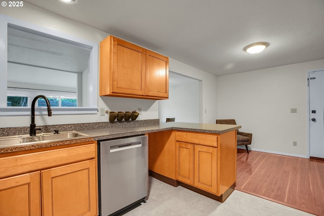 6410 SW 204th Pl, Beaverton, OR 97078 - kitchen with stainless steel dishwasher, dark countertops, a peninsula, and brown cabinetry