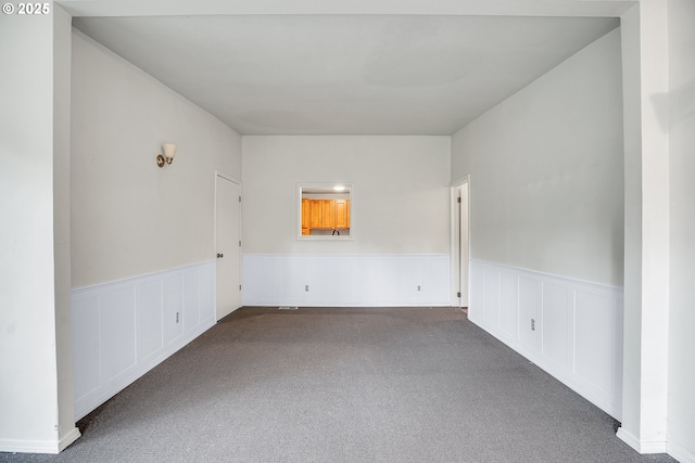6410 SW 204th Pl, Beaverton, OR 97078 - spare room with carpet flooring, a wainscoted wall, and a decorative wall