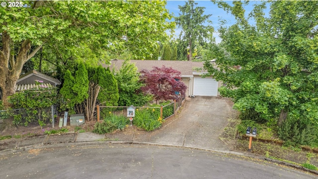 6410 SW 204th Pl, Beaverton, OR 97078 - view of property hidden behind natural elements with asphalt driveway, a garage, and view of scattered trees