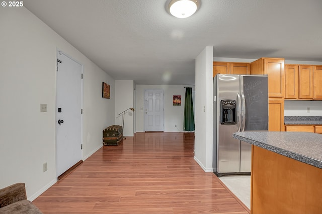 6410 SW 204th Pl, Beaverton, OR 97078 - kitchen featuring stainless steel refrigerator with ice dispenser, light wood-style floors, dark countertops, and a textured ceiling