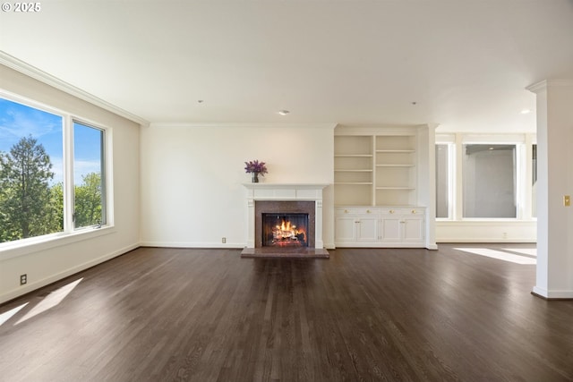 616 NW Westover Ter, Portland, OR 97210 - unfurnished living room with a lit fireplace, dark wood-style flooring, baseboards, and crown molding